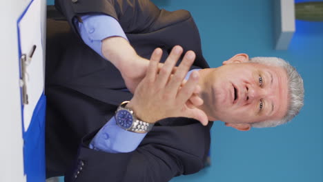 Vertical-video-of-Excited-businessman-clapping-at-camera.